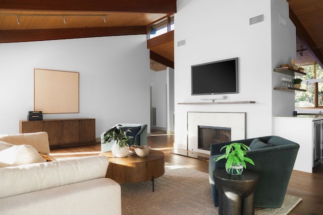 1400 Mount Larson Rd, Austin, TX 78746 - living area featuring wooden ceiling with exposed beams, high vaulted ceiling, wood finished floors, and a fireplace