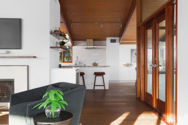 1400 Mount Larson Rd, Austin, TX 78746 - living room with wooden ceiling, wood finished floors, french doors, and a fireplace
