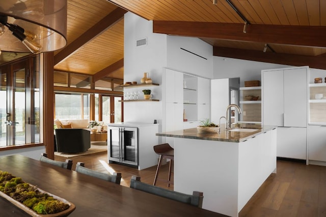 kitchen with lofted ceiling with beams, modern cabinets, open shelves, visible vents, and wood ceiling