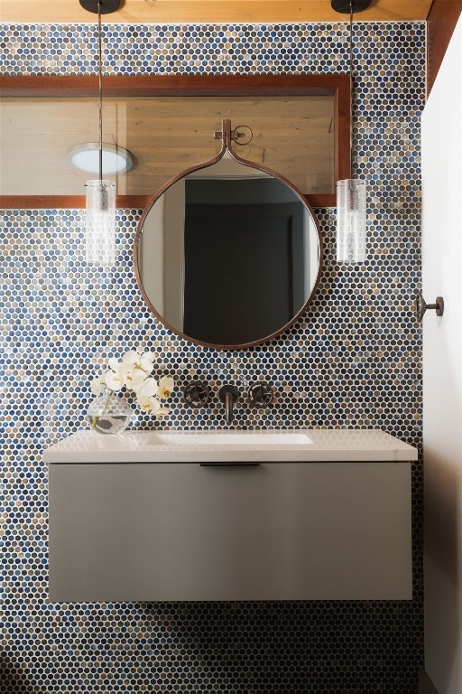 1400 Mount Larson Rd, Austin, TX 78746 - bathroom featuring a sink and decorative backsplash