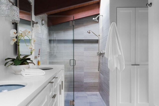 1400 Mount Larson Rd, Austin, TX 78746 - full bathroom featuring a shower stall, double vanity, and tile patterned floors