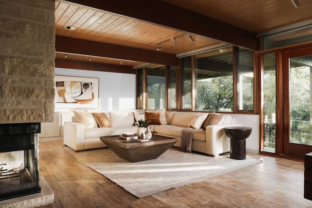 1400 Mount Larson Rd, Austin, TX 78746 - living area with wood finished floors, wood ceiling with exposed beams, and a multi sided fireplace