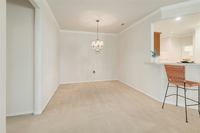 unfurnished dining area featuring baseboards, carpet floors, ornamental molding, and an inviting chandelier