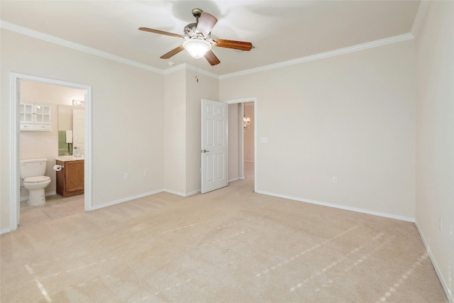 unfurnished bedroom featuring crown molding, light colored carpet, ceiling fan, ensuite bathroom, and baseboards