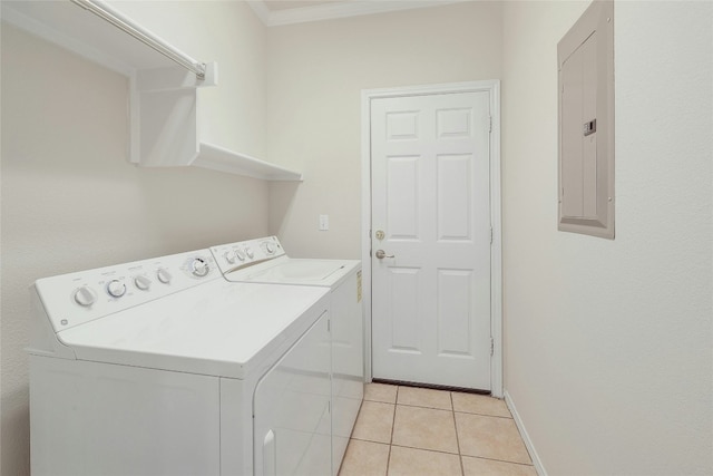 washroom with laundry area, light tile patterned floors, electric panel, baseboards, and washer and dryer