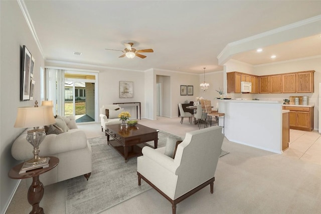 living area featuring light carpet, ornamental molding, and ceiling fan with notable chandelier