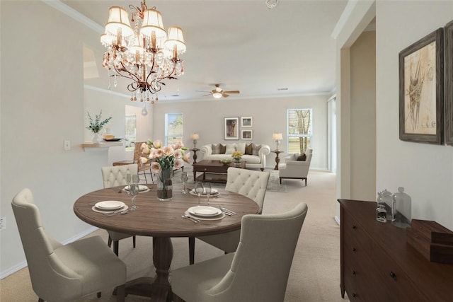 dining room with ornamental molding, ceiling fan with notable chandelier, light colored carpet, and plenty of natural light