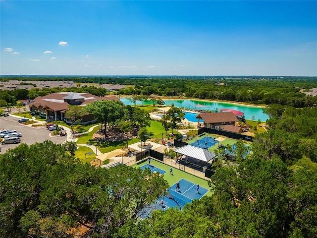 birds eye view of property with a water view and a view of trees
