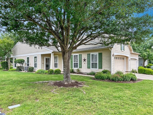 view of front of property with concrete driveway, a front yard, and an attached garage
