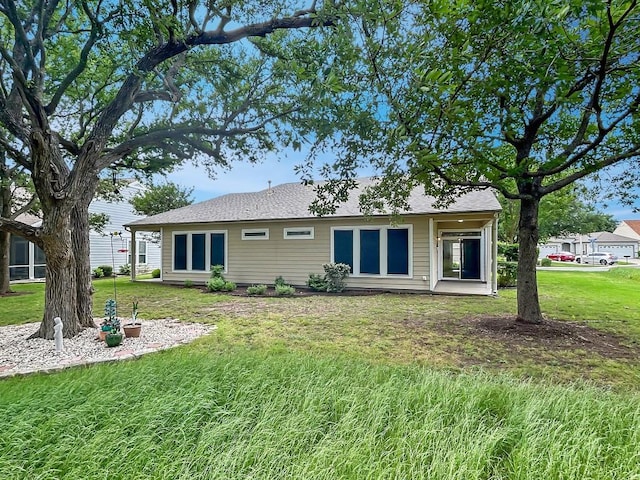 back of property with a yard