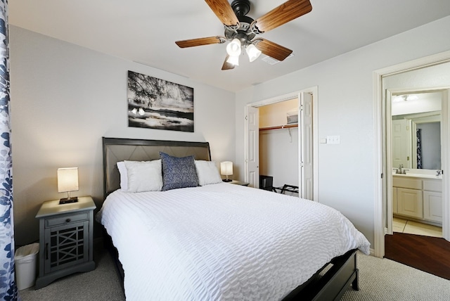 carpeted bedroom with a ceiling fan and a closet