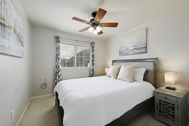 carpeted bedroom featuring baseboards and a ceiling fan