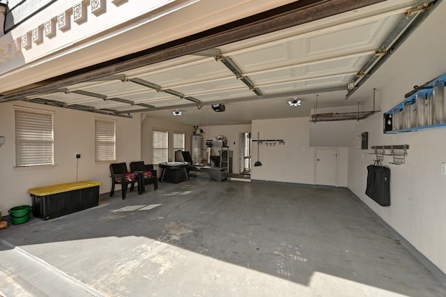 garage featuring a garage door opener and water heater