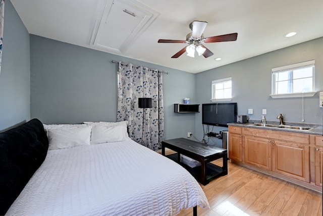 bedroom featuring ceiling fan, recessed lighting, a sink, light wood-style floors, and attic access