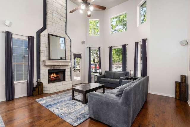 1601 Forest St, Georgetown, TX 78626 - living area with ceiling fan, a high ceiling, a fireplace, hardwood / wood-style floors, and baseboards