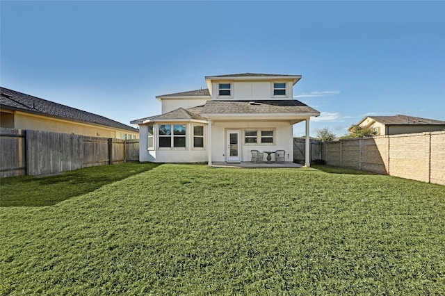 back of house with a lawn, a fenced backyard, a patio area, and stucco siding