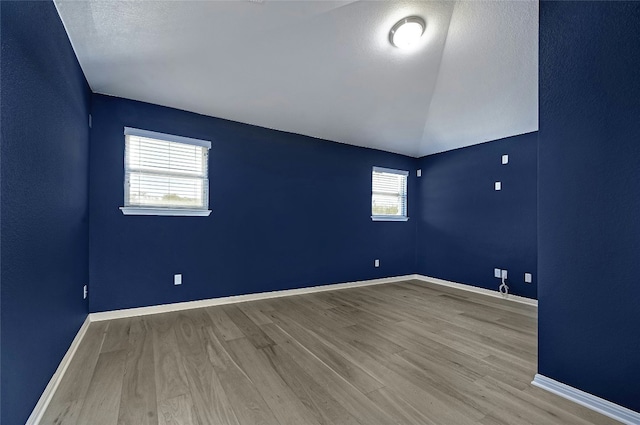 empty room with baseboards and wood finished floors