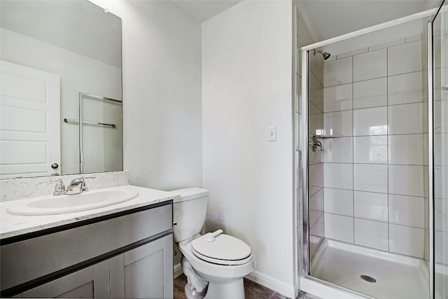 full bathroom with vanity, baseboards, toilet, and a shower stall