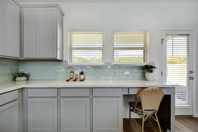 bar featuring decorative backsplash and wood finished floors