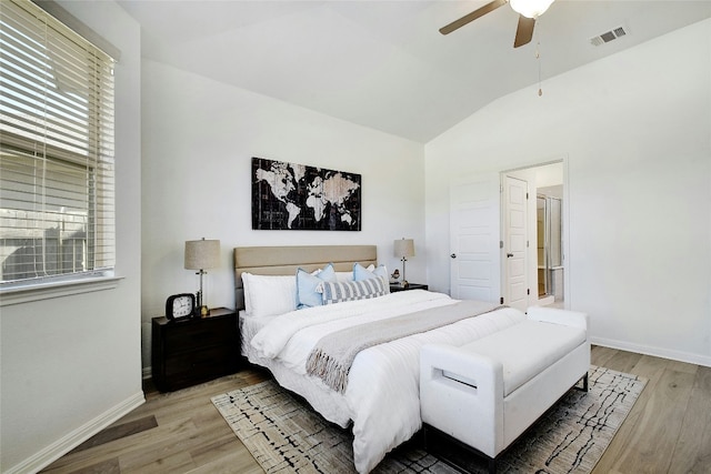 bedroom with multiple windows, lofted ceiling, light wood-type flooring, and visible vents