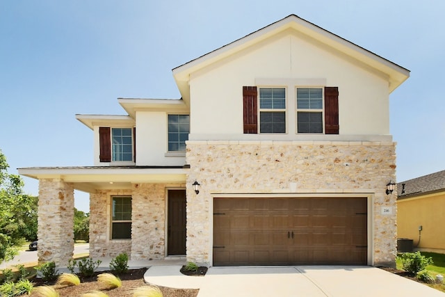 view of front of property featuring an attached garage, stucco siding, driveway, and stone siding