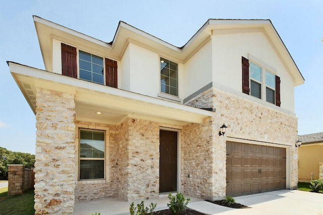 contemporary house featuring stucco siding, concrete driveway, stone siding, and a garage