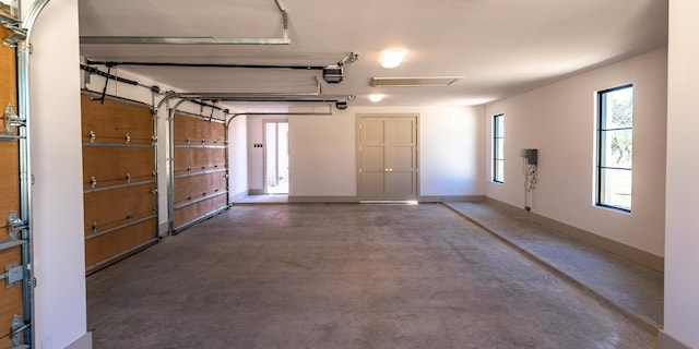 garage with baseboards and a garage door opener