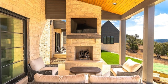 view of patio / terrace with an outdoor living space with a fireplace