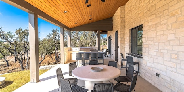 view of patio featuring exterior kitchen and outdoor dining area