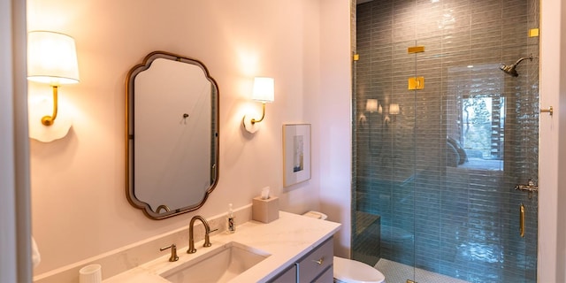 full bath featuring toilet, a shower stall, and vanity