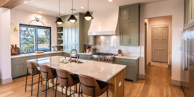179 Lagrange Dr, Fredericksburg, TX 78624 - kitchen with custom exhaust hood, high end stainless steel range oven, gray cabinetry, open shelves, and tasteful backsplash
