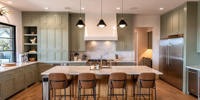 kitchen featuring light stone countertops, gray cabinets, light wood-type flooring, backsplash, and built in fridge