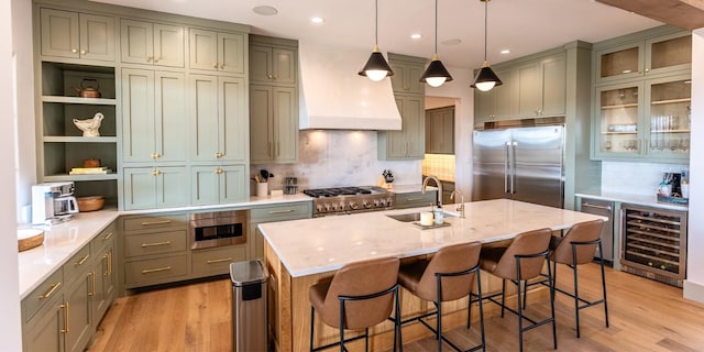 179 Lagrange Dr, Fredericksburg, TX 78624 - kitchen with beverage cooler, high quality appliances, custom exhaust hood, open shelves, and light wood-style floors