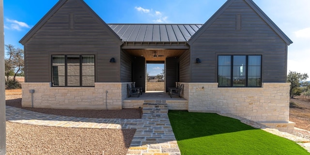 179 Lagrange Dr, Fredericksburg, TX 78624 - view of front of house with stone siding, a standing seam roof, and a metal roof