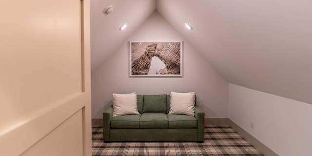 sitting room featuring lofted ceiling, carpet, and baseboards