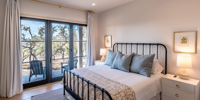 bedroom with access to exterior, light wood finished floors, and recessed lighting