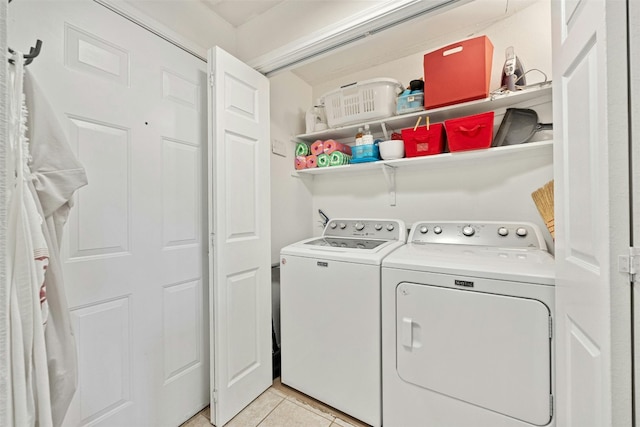 laundry room featuring laundry area, light tile patterned flooring, and separate washer and dryer