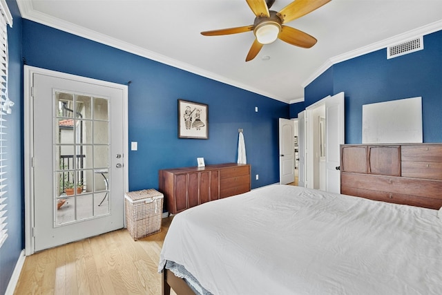 bedroom with visible vents, ornamental molding, ceiling fan, and wood finished floors