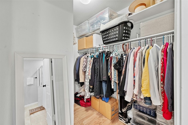 walk in closet featuring wood finished floors