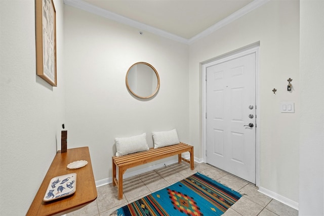 entrance foyer featuring baseboards, ornamental molding, and tile patterned floors