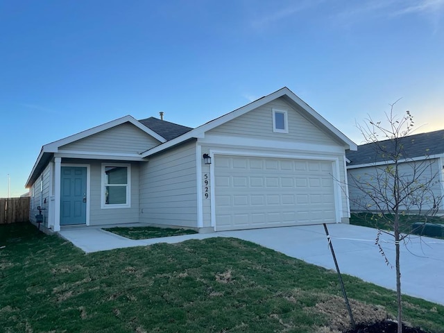 ranch-style house with a garage, a front yard, driveway, and fence