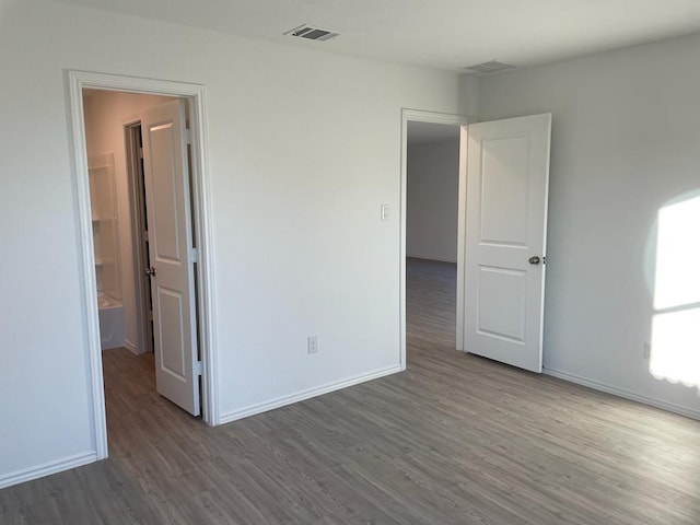 5929 Antonio Pl, Seguin, TX 78155 - unfurnished bedroom with visible vents, baseboards, and wood finished floors