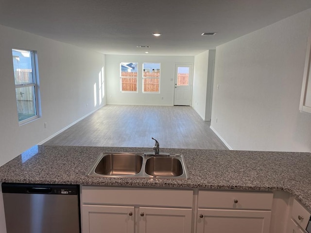 5929 Antonio Pl, Seguin, TX 78155 - kitchen featuring stainless steel dishwasher, a sink, visible vents, and white cabinetry