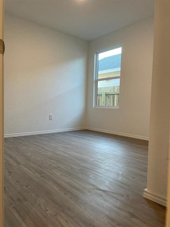 5929 Antonio Pl, Seguin, TX 78155 - unfurnished room with baseboards and dark wood-style flooring