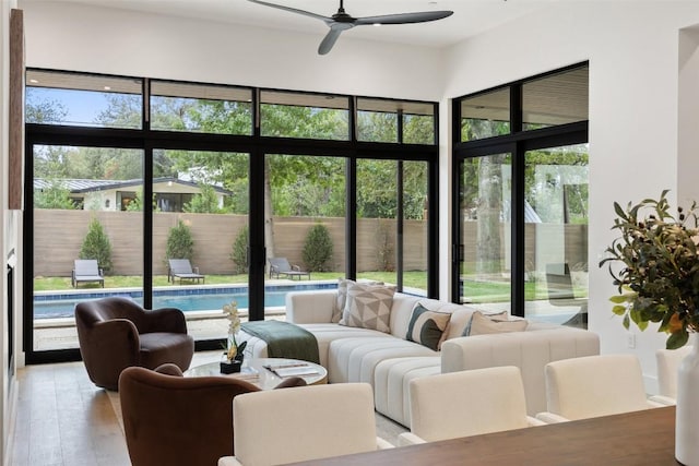 sunroom featuring ceiling fan