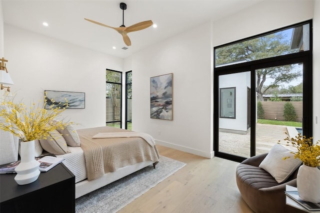 bedroom featuring visible vents, baseboards, light wood-style flooring, recessed lighting, and access to outside