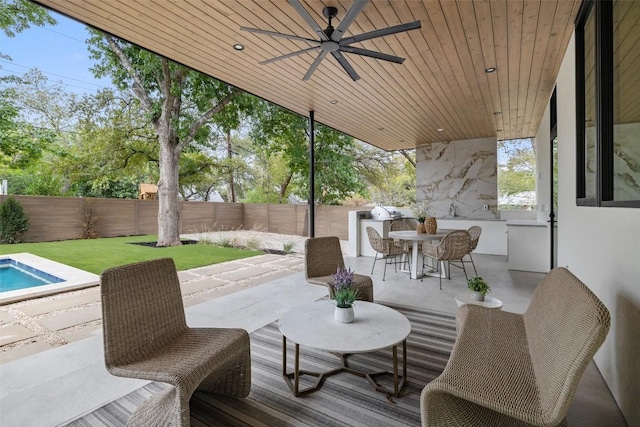 view of patio with outdoor dining space, ceiling fan, a fireplace, and a fenced backyard