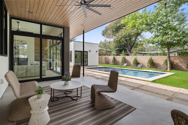 view of patio with a fenced in pool, a ceiling fan, and a fenced backyard