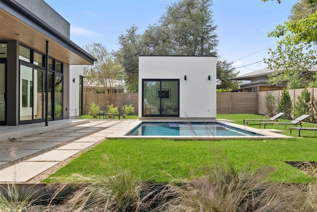 view of pool featuring an outbuilding, a lawn, a fenced backyard, and a fenced in pool