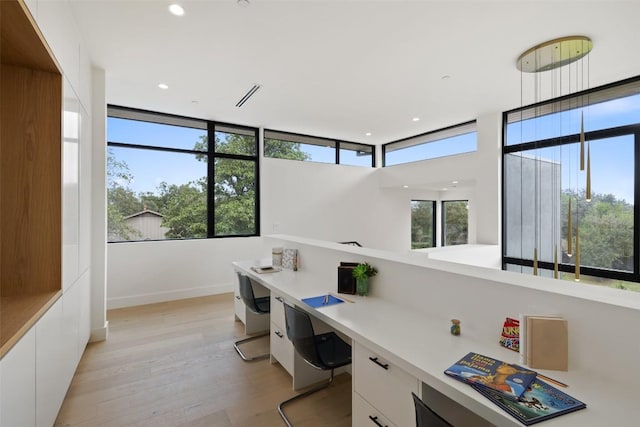 office featuring a healthy amount of sunlight, recessed lighting, light wood-style floors, and built in study area